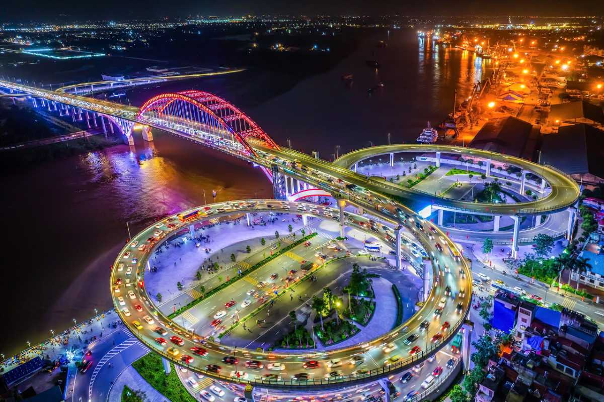 Hai Phong city skyline at night with illuminated bridges Nighttime cityscape of Hai Phong showcasing brightly lit bridges and busy roadways
