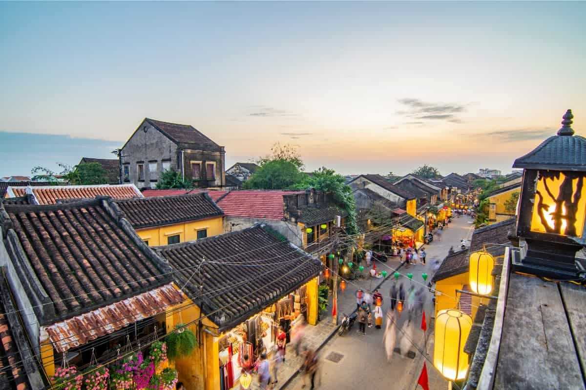 Busy Street with Pedestrians and Lanterns Colorful street decorated with lanterns, busy with tourists and locals in Hoi An