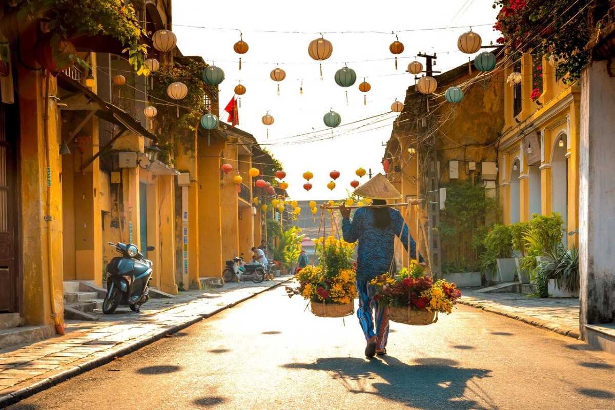 Busy Riverside Market with Boats and Tourists Crowded riverside market in Hoi An Ancient Town with colorful boats and tourists