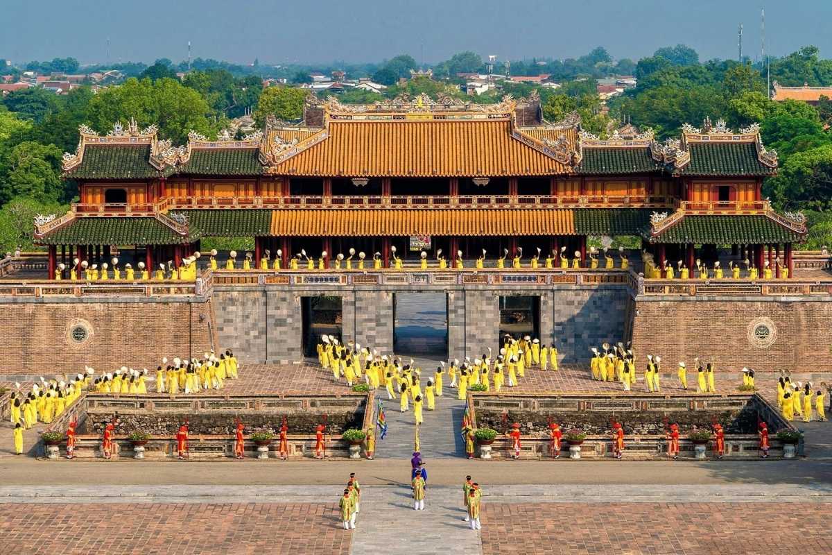 Hue Travel Guide Imperial City Ceremony with Traditional Dress Hue Travel Guide highlights a traditional ceremony inside the Imperial City with participants in colorful historic dress.