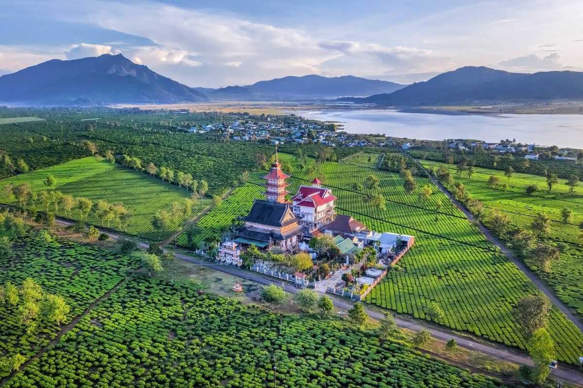 Panoramic Lake View with Town in Gia Lai Wide panoramic view of a lake surrounded by hills and a town visible on the shoreline