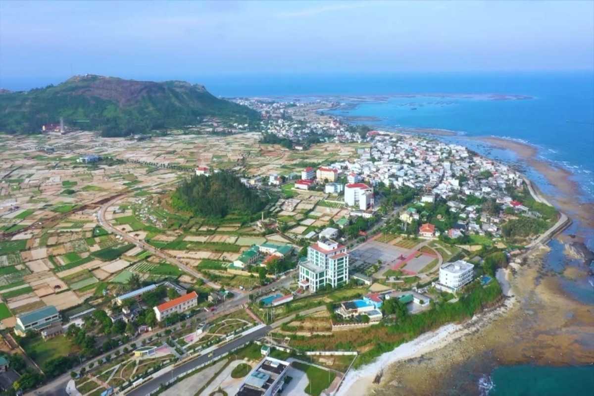 Quang Ngai Coastal Town and Agricultural Fields Aerial view of Quang Ngai coastal town with agricultural fields stretching to the sea in Vietnam.