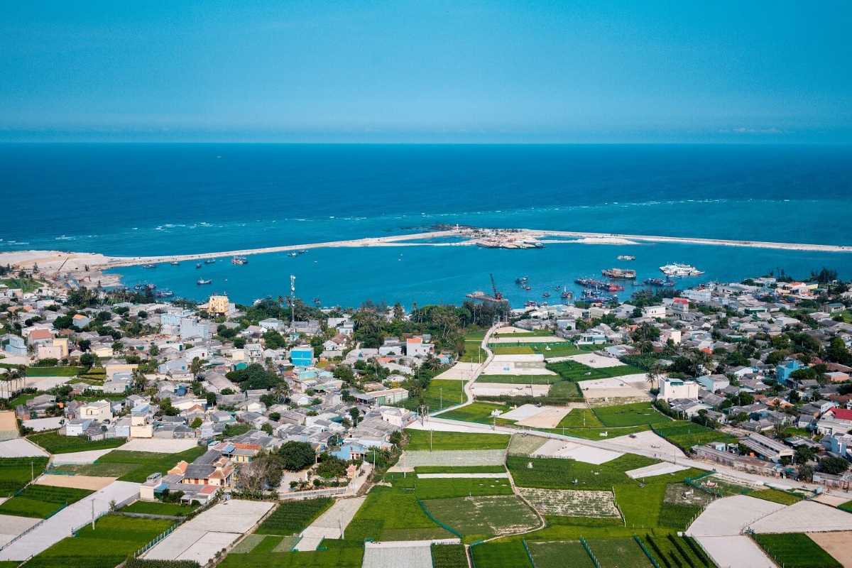 Quang Ngai Ly Son Island Aerial Coastal Village View Aerial view of Ly Son Island coastal village with fishing boats and turquoise sea in Quang Ngai.