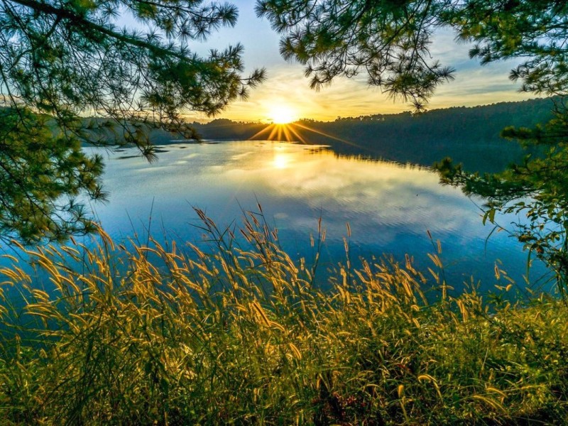 Sunrise over the peaceful waters of Ta Nung Lake in Gia Lai