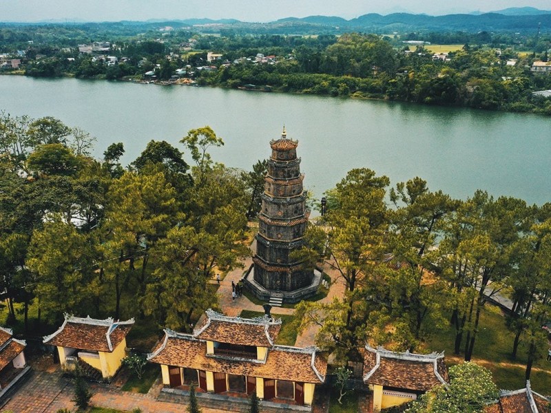 Thien Mu Pagoda in Hue, standing tall beside the Perfume River, offering panoramic views of the surrounding landscape.