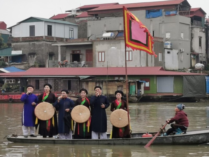 Locals performing traditional songs on a boat during the Tho Ha Village Festival in Bac Giang