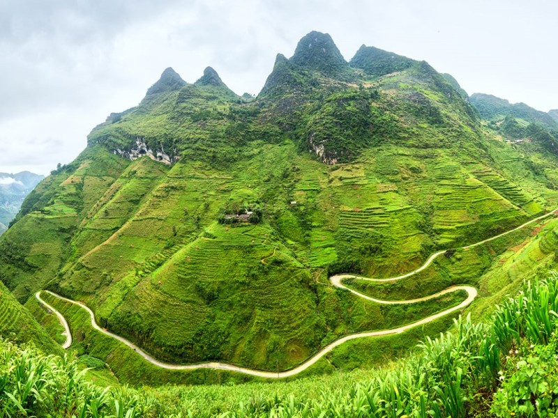 Tourists exploring the Ha Giang province in Vietnam, showcasing the scenic routes and cultural richness of the region.