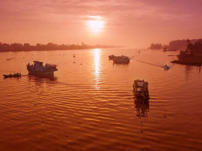 Boats at Tra On Floating Market during sunrise in Vinh Long Province