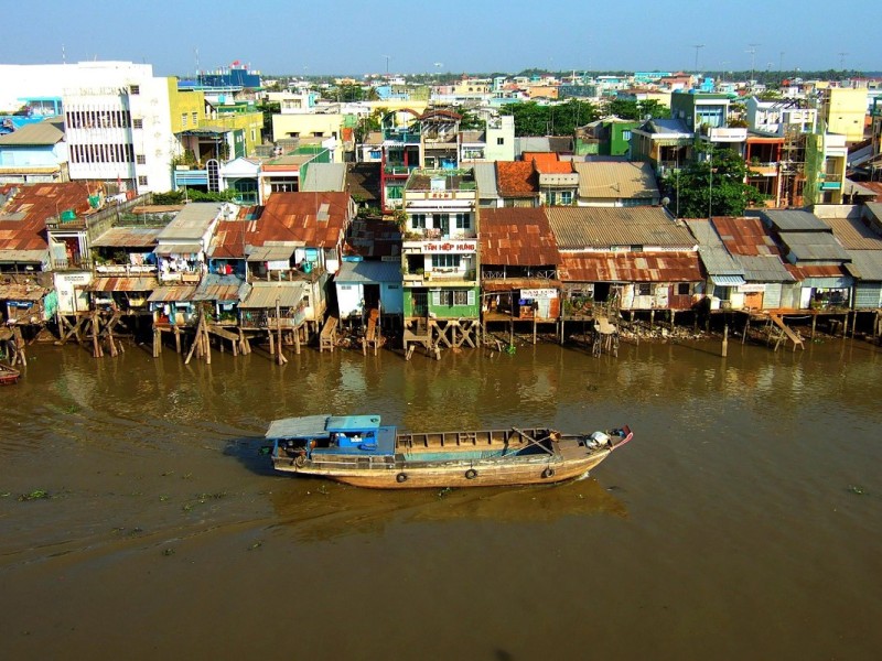 Tourists enjoying the traditional market scene in My Tho, a cultural hub in the Mekong Delta.