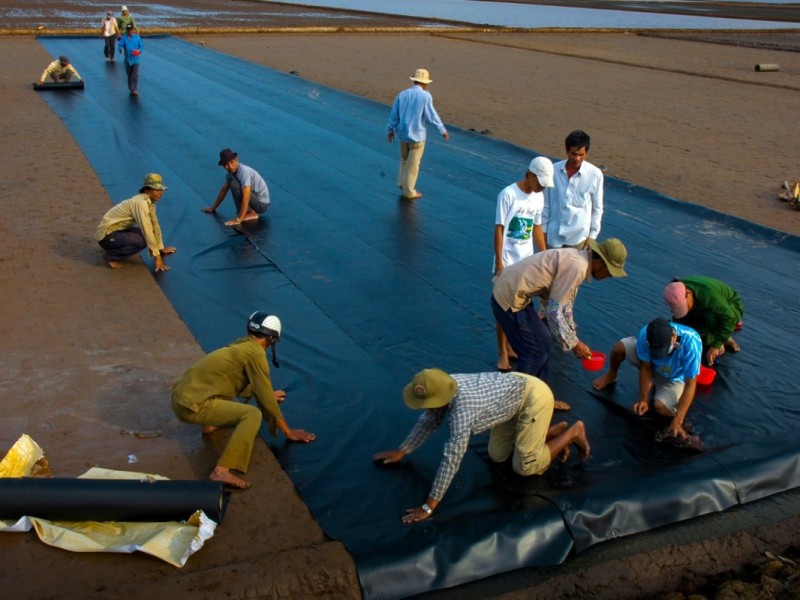 Traditional salt harvesting process at Bac Lieu salt farm