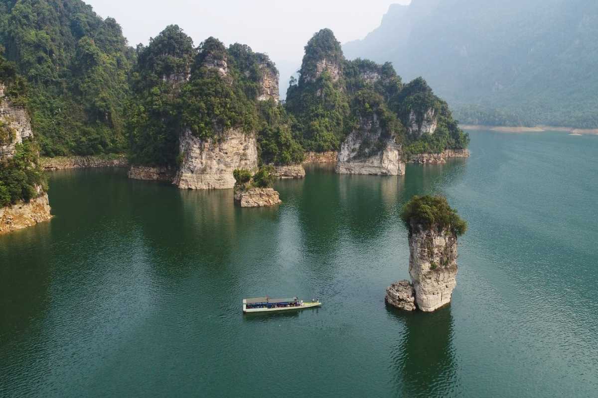 Tuyen Quang Limestone Karsts and Boat Tour Scenic boat tour on calm lake waters with towering limestone karsts in Tuyen Quang