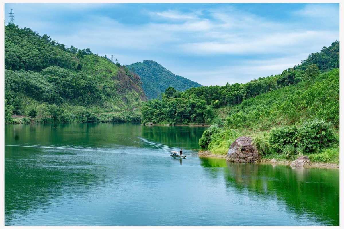 Tuyen Quang Remote Lake with Forested Hills Remote peaceful lake nestled among forested hills and mountains in Tuyen Quang