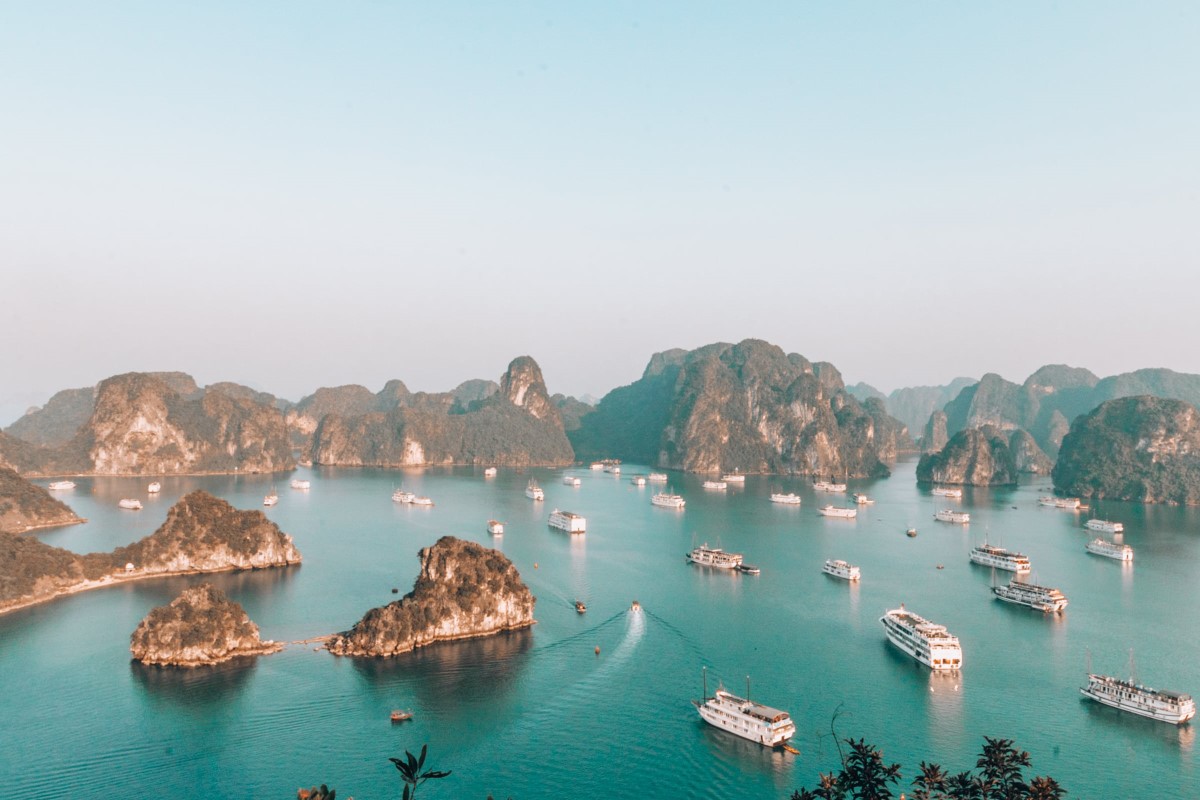 An aerial view of Ha Long Bay, featuring towering limestone islands and turquoise waters.