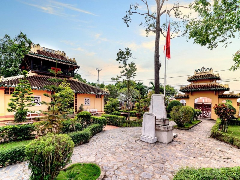 Exterior view of Vinh Long Temple of Literature surrounded by lush greenery