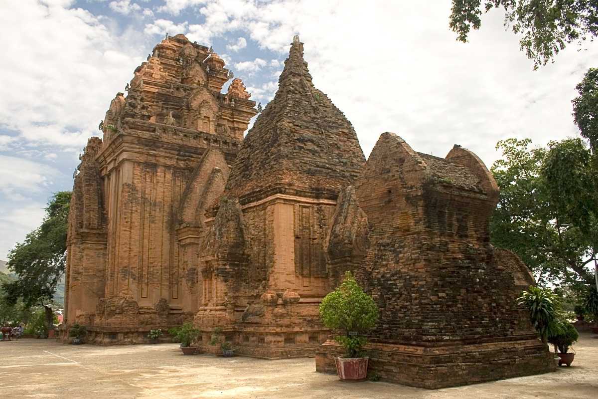 Ancient weathered towers of Ponagar Temple showcasing Cham architecture in Nha Trang under soft daylight during the half-day tour.