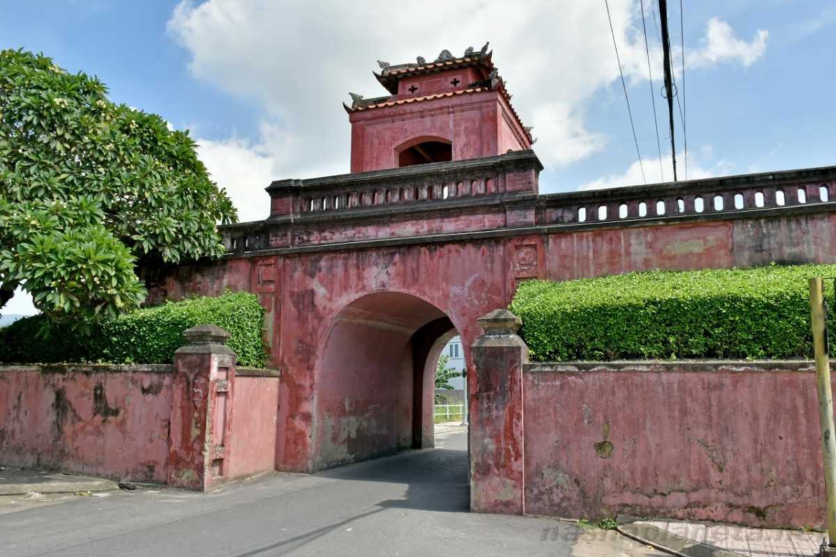 Dien Khanh Citadel main gate and defensive walls surrounded by greenery and blue sky