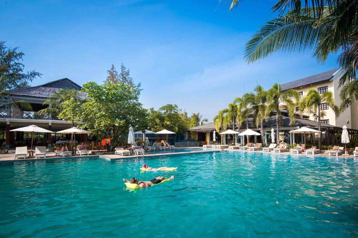 Travelers unwind in the spacious pool of Eden Resort in Phu Quoc before their 3 island speedboat tour.