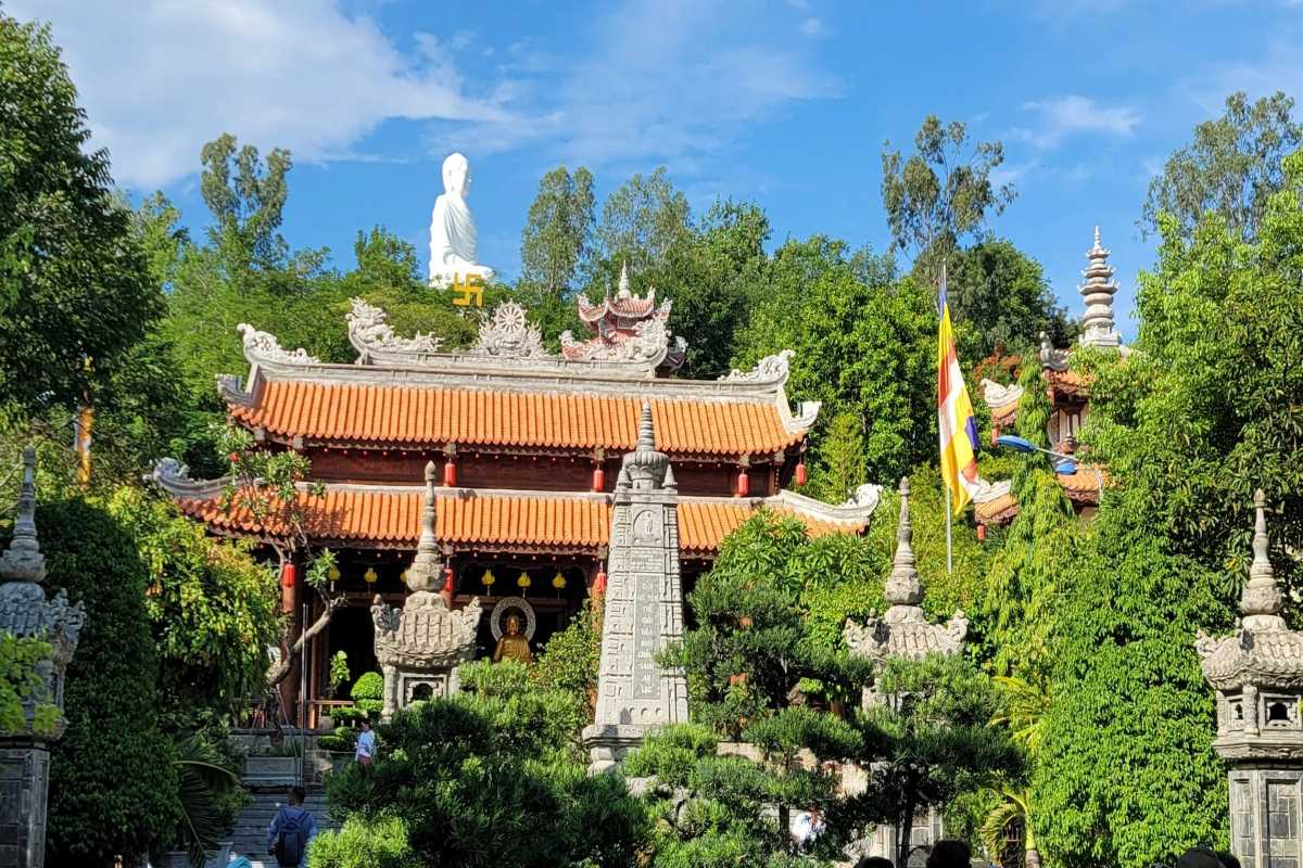 View of Long Son Pagoda during Kong Forest Hiking tour surrounded by lush greenery