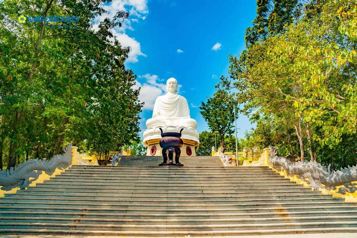Massive white Buddha statue atop a staircase at Long Son Pagoda on the Nha Trang countryside biking tour