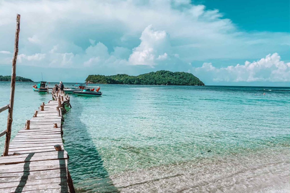 Shimmering shoreline and distant islet views from the beach at May Rut Island, part of the Phu Quoc tour.