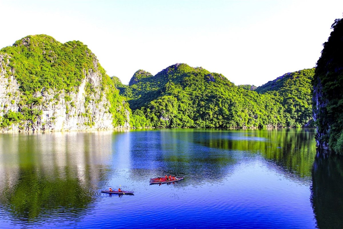 Scenic view of Cat Ba Island surrounded by Halong Bay's emerald waters and limestone formations.